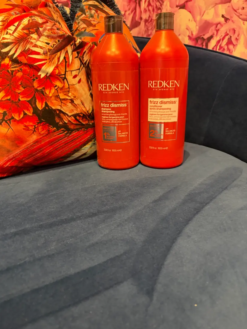Redken Frizz Dismiss shampoo and conditioner displayed inside Danielle Sarah Salon